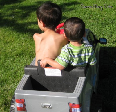 pictures of two boys in a toy truck