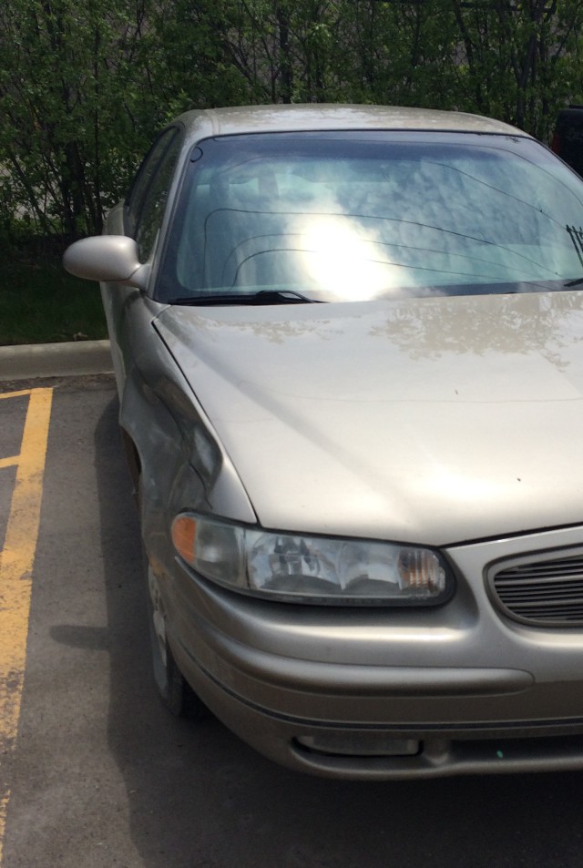 image of the damaged front corner of a 2002 Buick Regal beige