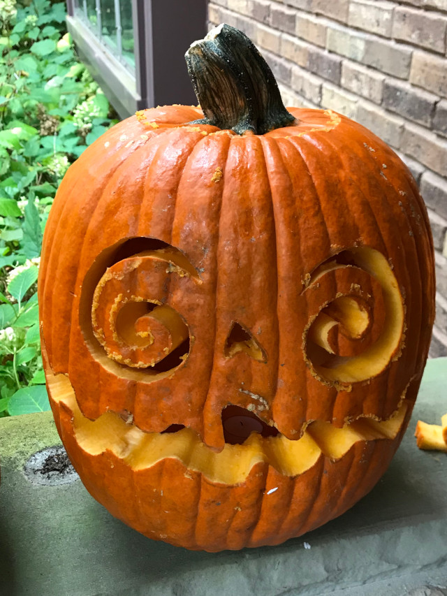 image of some carved pumpkin jack-o-lanterns during the day