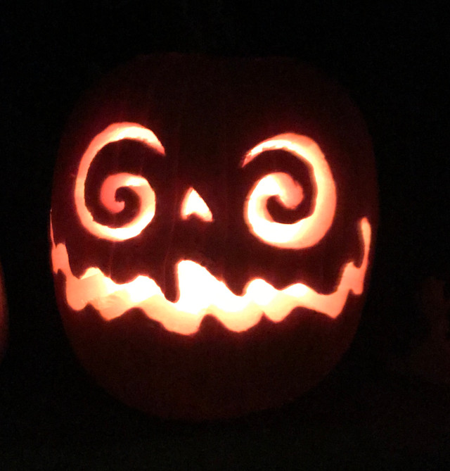 image of some carved pumpkin jack-o-lanterns during the night
