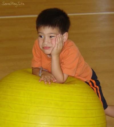 picture of a bored boy with a ball