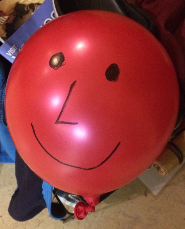 image of a face drawn on a balloon with marker