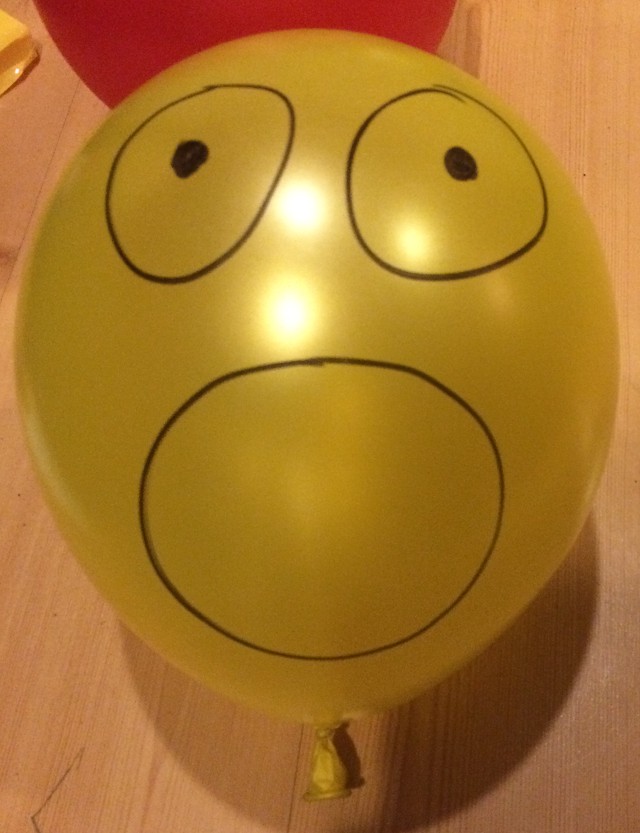 image of a face drawn on a balloon with marker