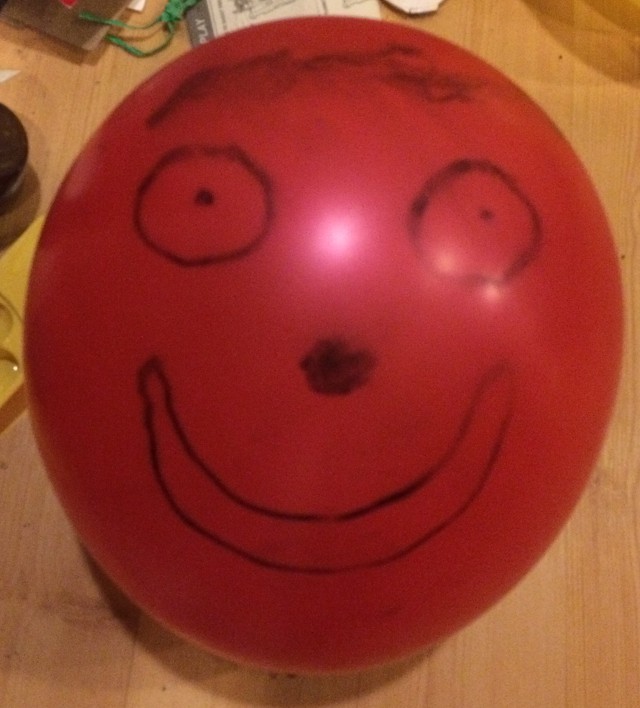 image of a face drawn on a balloon with marker