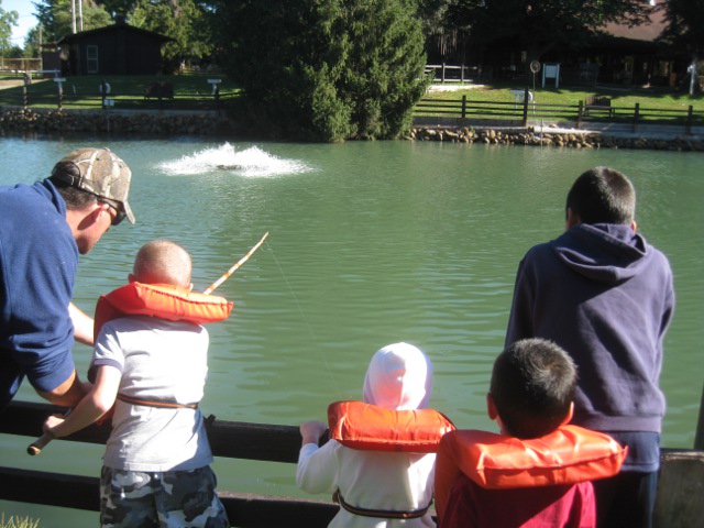 kids at a trout farm fishing pond