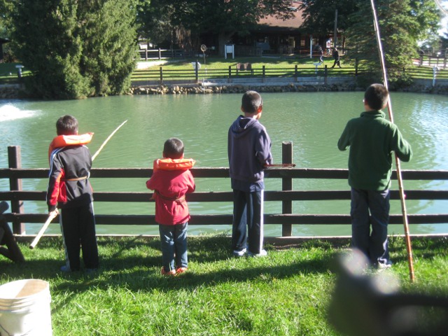 kids at a trout farm fishing pond