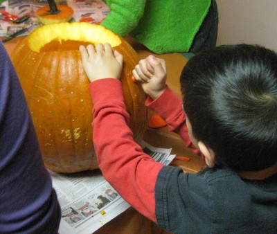 picture of someone carving a pumpkin into a jack-o-lantern