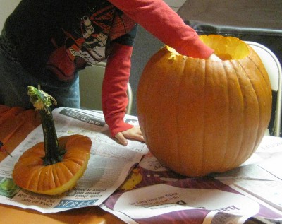 picture of someone scooping seeds out of a pumpkin