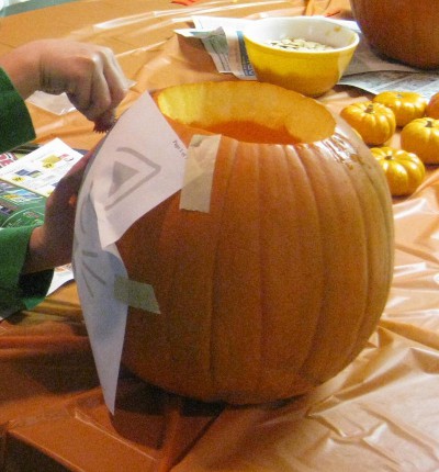 picture of someone carving a pumpkin into a jack-o-lantern