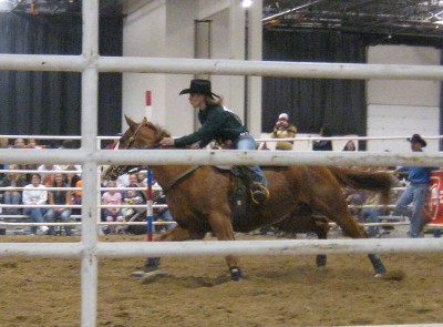 photo of rodeo horse racing around the slalom pole