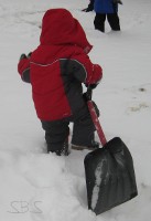 picture of a child pulling a snow shovel