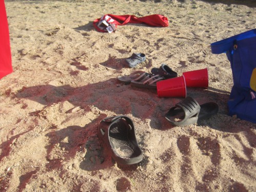 sandals and toys on the beach