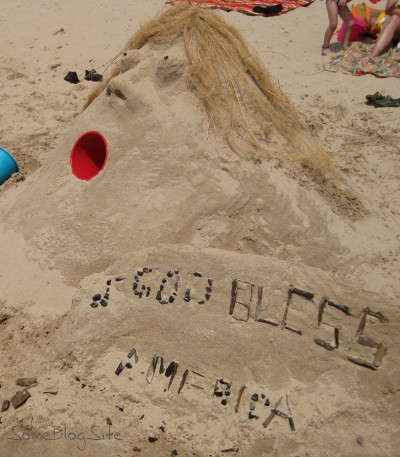 sand sculpture of a woman singing God Bless America