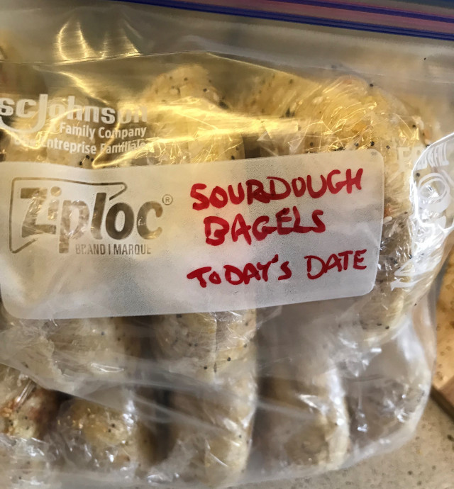 image of a freezer bag of bagels with today's date written on it.