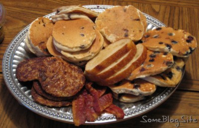 platter filled with breakfast food of pancakes, sausage, and bacon