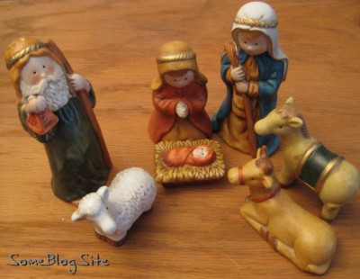 small ceramic Nativity scene on a wood background