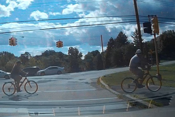 image of some bicyclists crossing at a cross walk