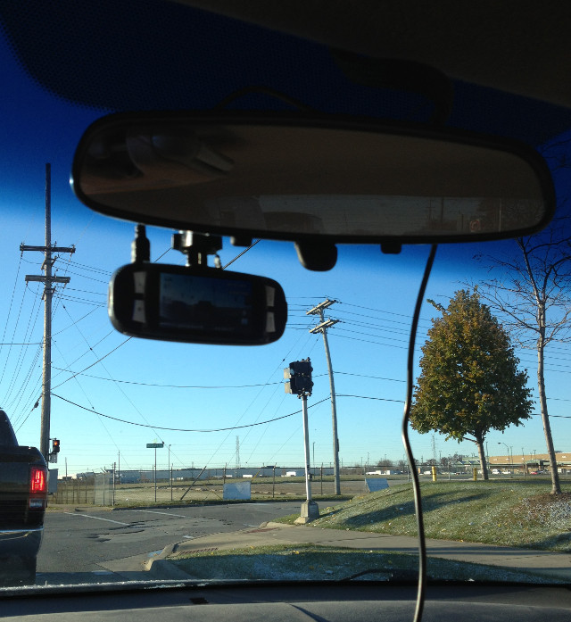 photo of a G1W dash cam installed on a windshield under a rearview mirror