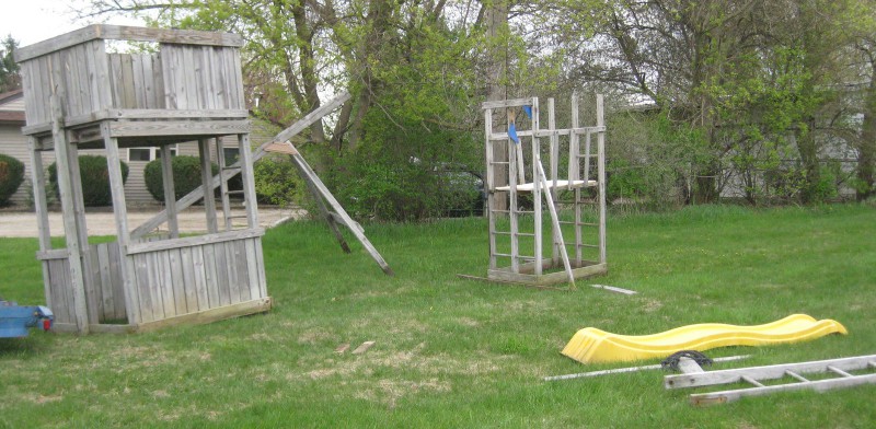 picture of a wooden play structure still needing some assembly
