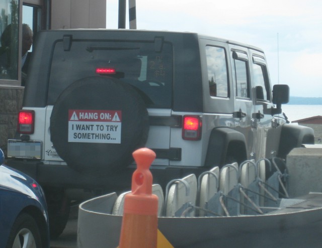 image of a Jeep with a bumper sticker that says Hang on I want to try something