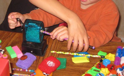 picture of children sharpening pencils for Operation Christmas Child