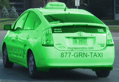 picture of a white car that claims to be a green taxi