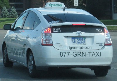 picture of a white car that claims to be a green taxi
