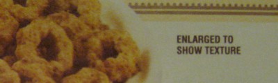 photo of the disclaimer on a box of cereal that the picture has been enlarged to show texture