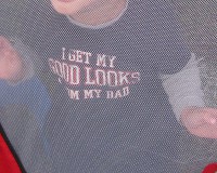 photo of child's shirt that says 'I get my good looks from my dad'