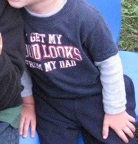 photo of child's shirt that says 'I get my good looks from my dad'