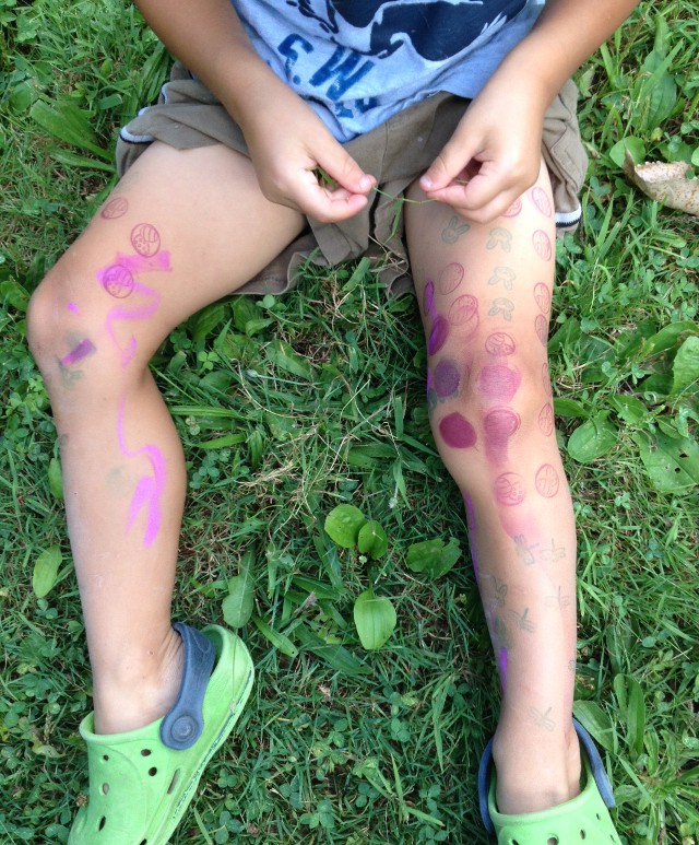 image of a child with ink stamps all over his legs
