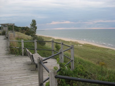 railing atop a hill overlooking a beach on Lake Michigan