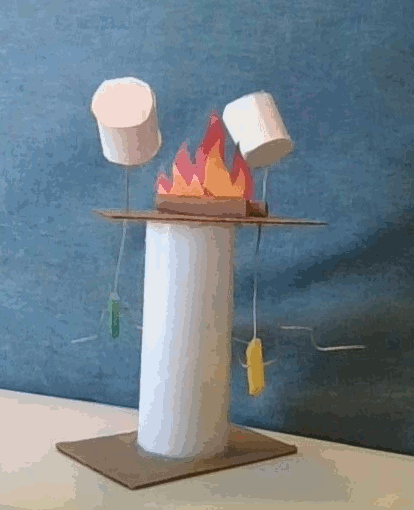 image of a cranky contraption showing marshmallows roasting on an open fire or campfire