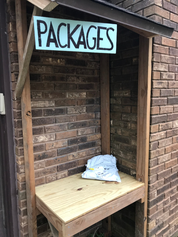 image of a shelter nook shelf with a roof built for delivery of packages boxes and bags