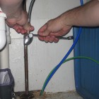 metal T connected from sink supply to 3/4-inch plastic tubing