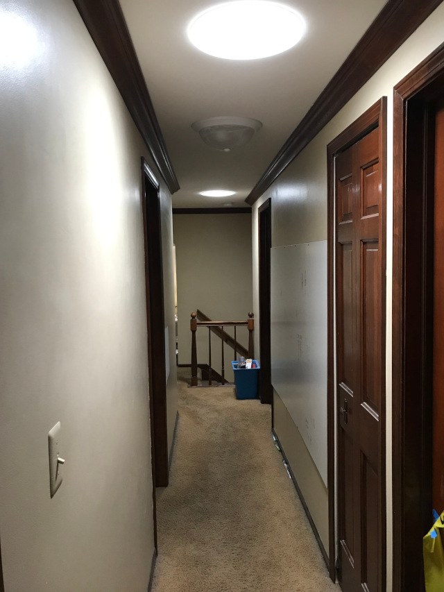 image of a hallway that is bright because of skylight tubes
