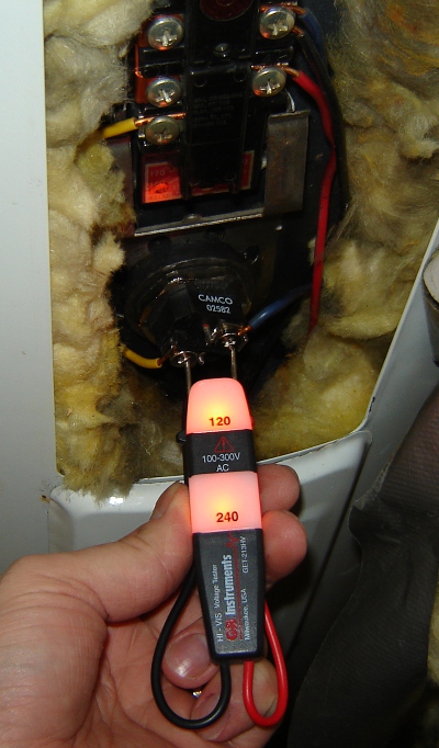 picture of a multimeter measuring resistance of a bad water heater element