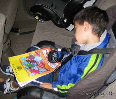 child who fell asleep in his car seat while holding a hockey puck