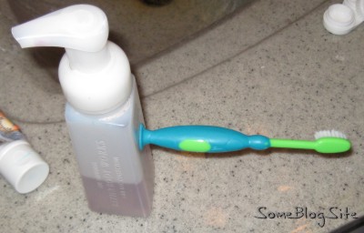 Picture of a toothbrush stuck to a soap dispenser