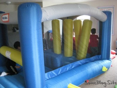 photo of children playing in an inflatable bounce house