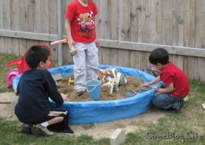 photo of children playing in a sandbox