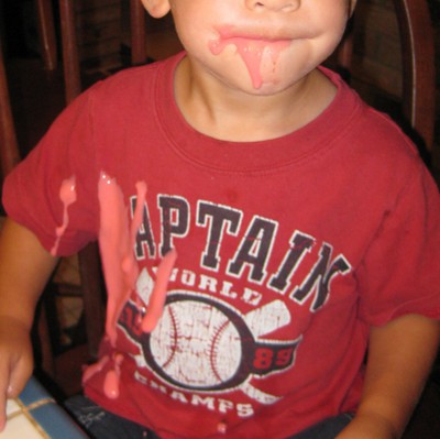 child with yogurt on his face and shirt