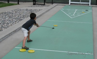 picture of a child playing shuffleboard