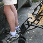 picture of legs and a stroller as seen at the eye level of a young child