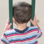picture of a child with his head caught between railings