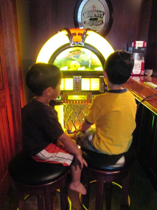photo of kids watching a jukebox