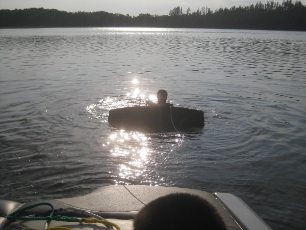 photo of some guy getting ready to wakeboard in a lake