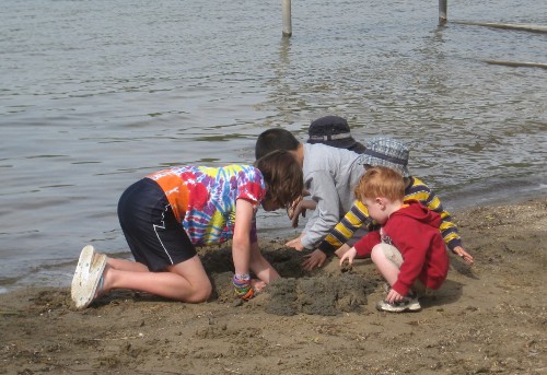 photo of children digging in the sand at Pokagon State Park in Angola Indiana
