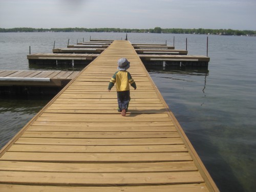 photo of a child walking on the dock at Pokagon State Park in Angola Indiana
