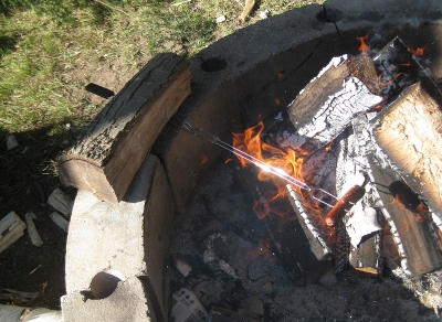 picture of a hot dog over a campfire